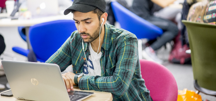 Student using a laptop in the library