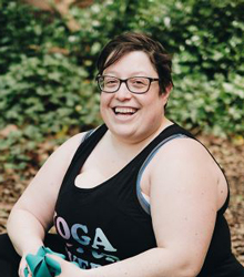Miriam Zendle, Classical Civilisation graduate, sitting outdoors on a yoga mat