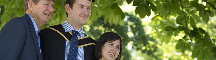 graduate with family members
