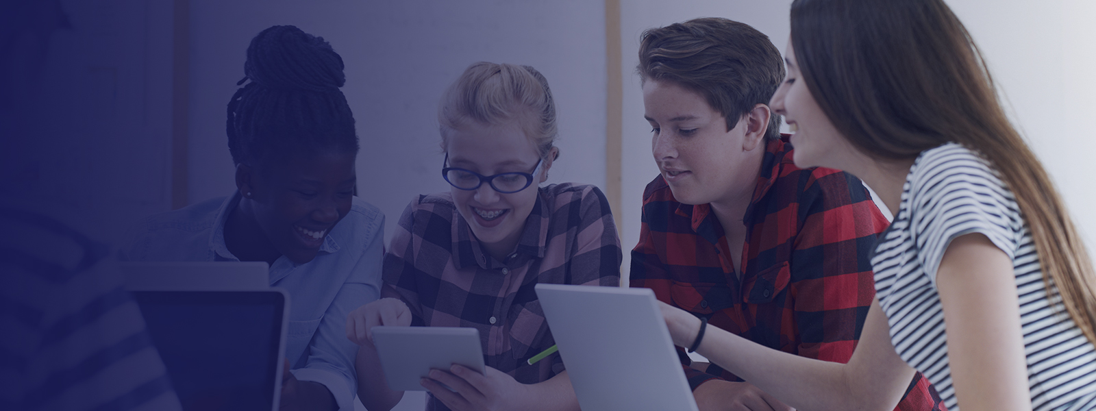 Group of young people smiling looking at iPads