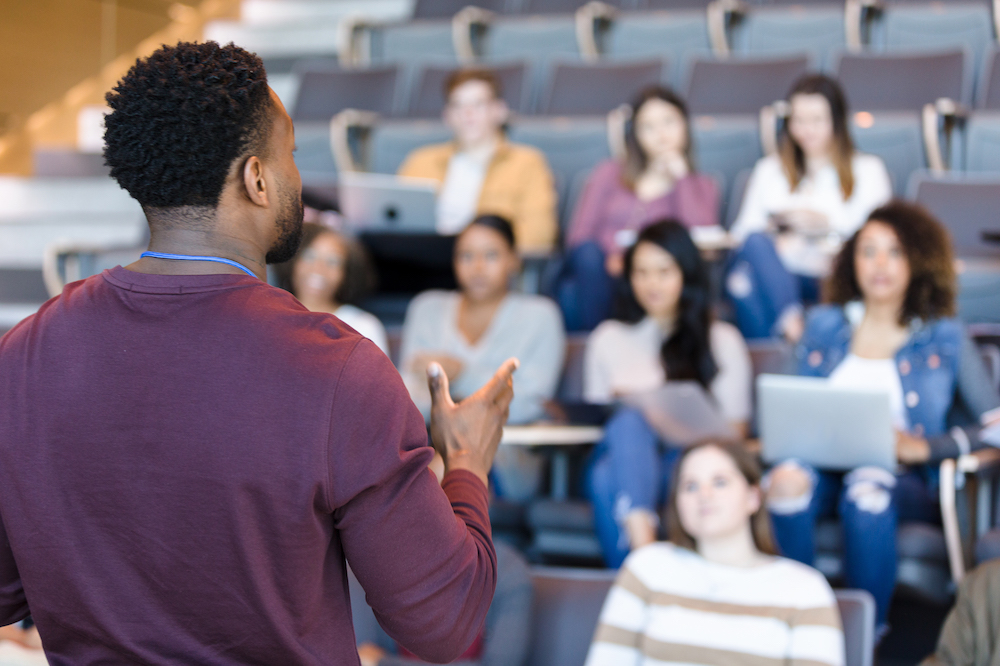 Lecturer presenting to students in a lecture theatre