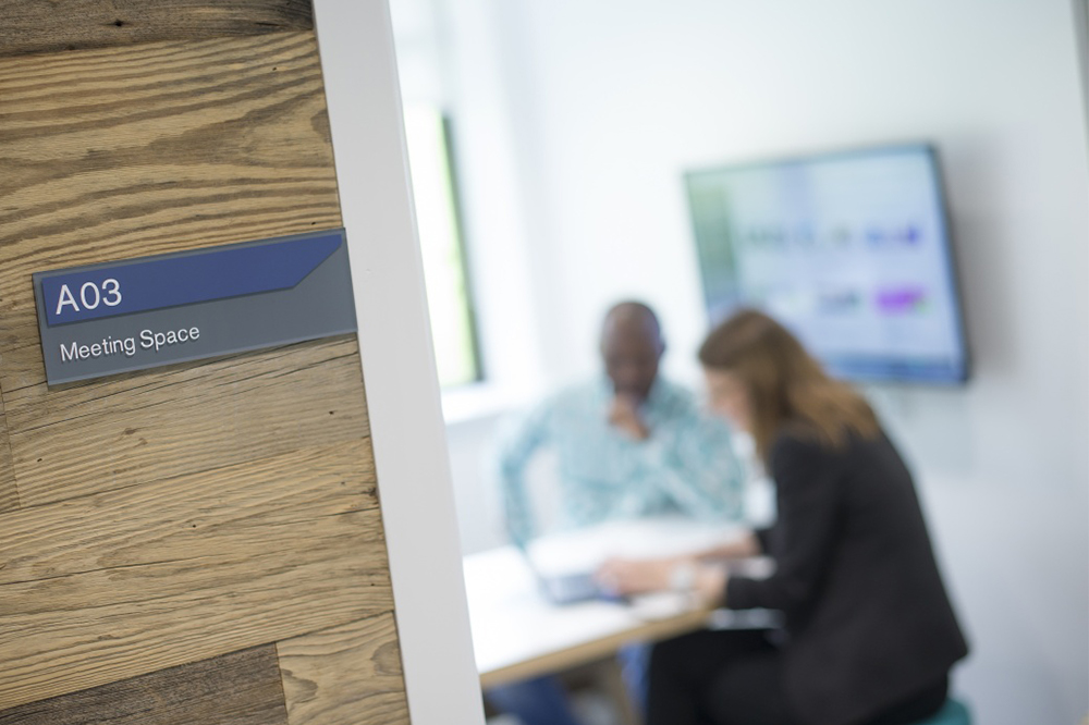 Student in a meeting room with a member of staff