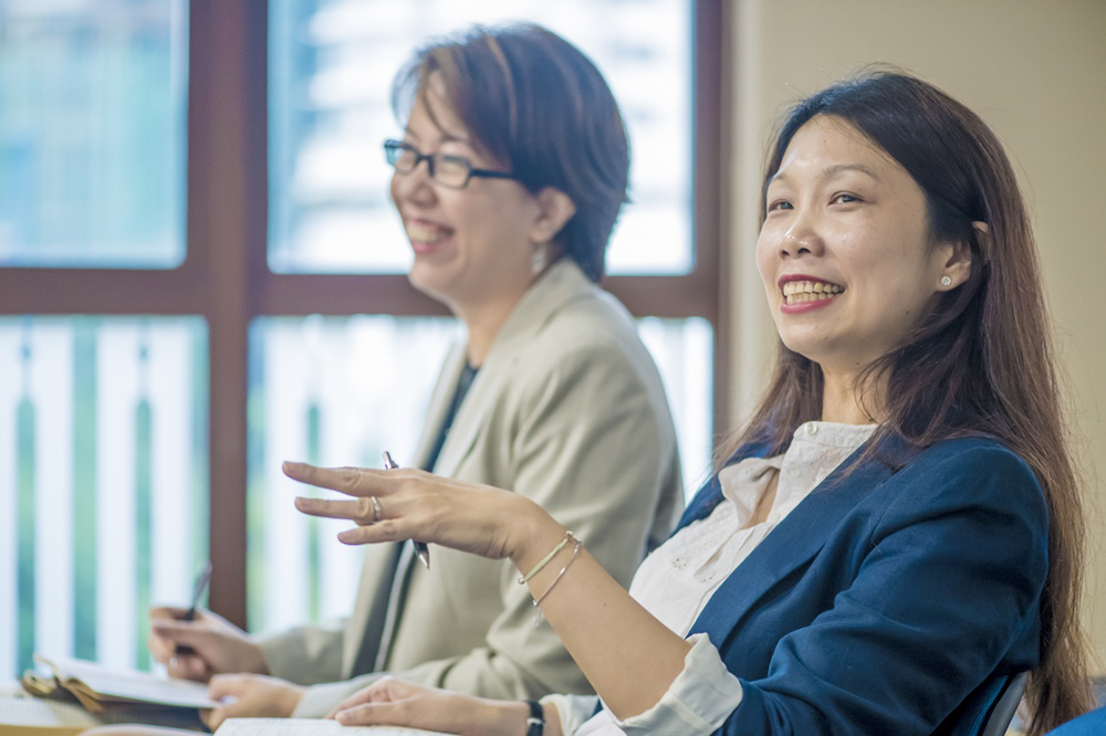 Two staff members sat in a seminar room