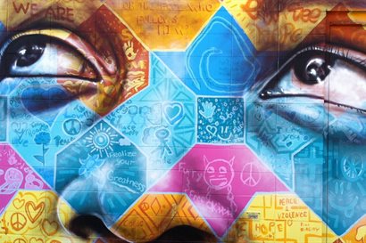 Painted wall mural of young face looking up