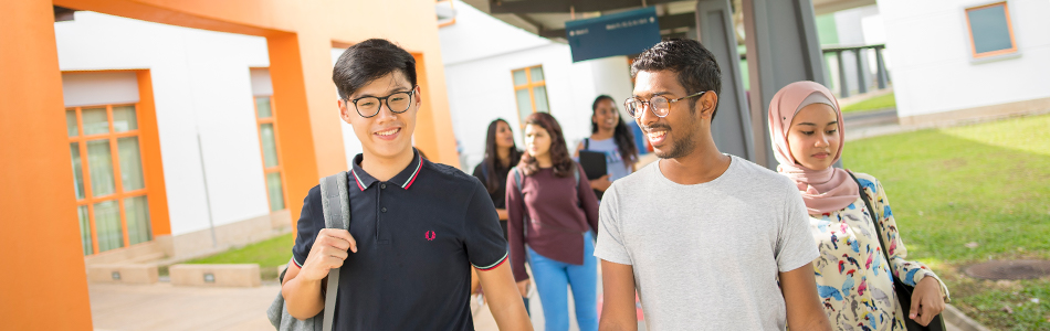 International students walking on a covered footpath on campus